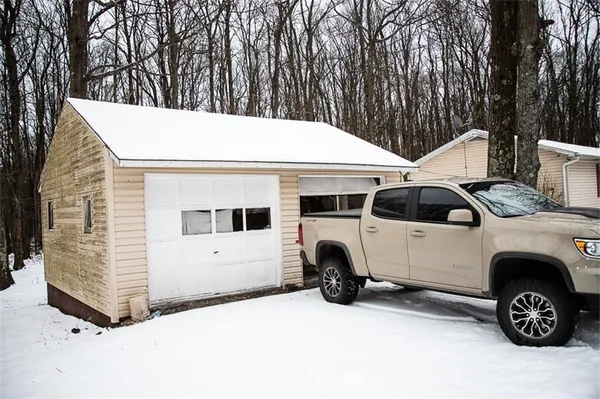 a view of a white house with large trees