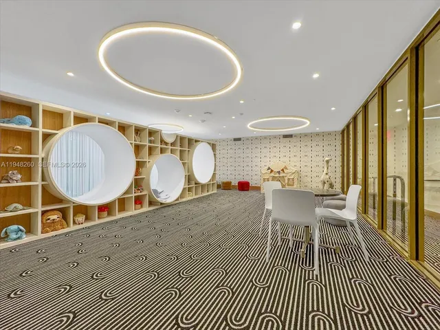 a living room with furniture a table and wooden floor