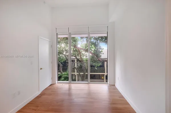a view of a room with wooden floor and windows