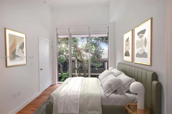 a bedroom with furniture and a large window