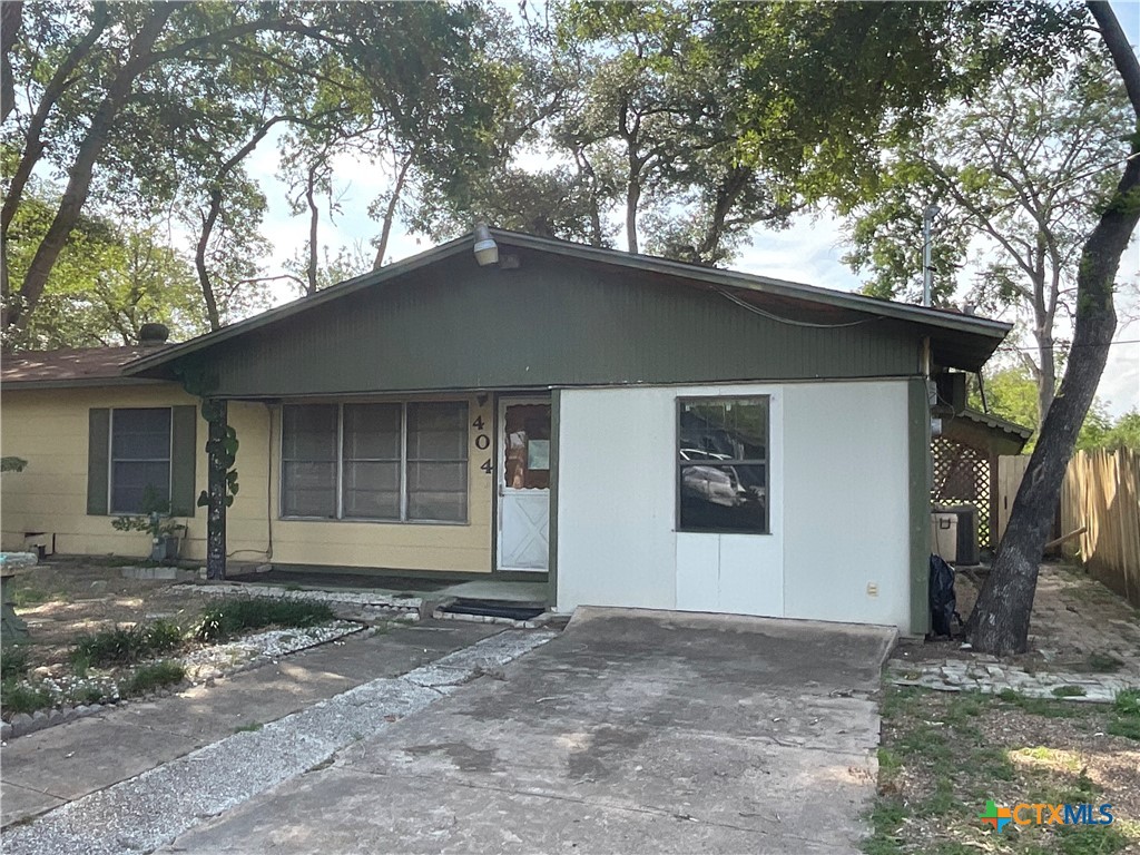 404 Svoboda Street Yoakum, TX 77995 - Photo 3 of 20 a front view of a house with a yard and garage