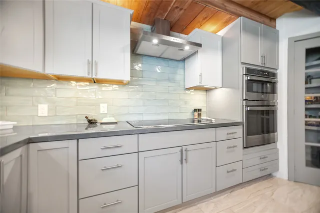 a kitchen with stainless steel appliances granite countertop a sink and cabinets