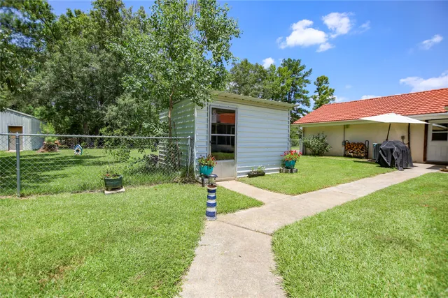 a house with green field in front of it