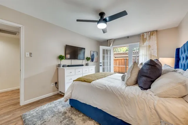 a bedroom with a large bed and a chandelier
