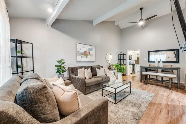 a living room with furniture and wooden floor