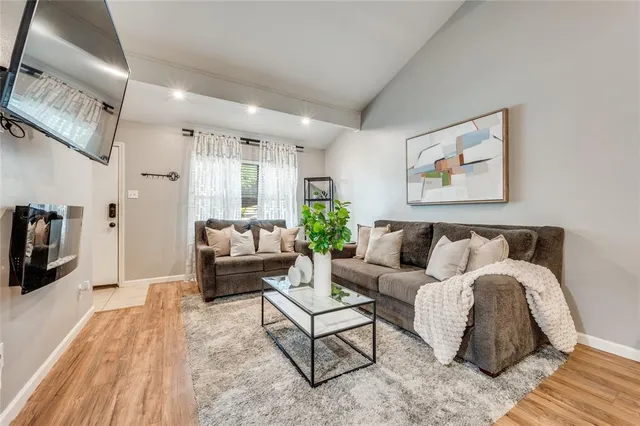 a living room with furniture or couch and a wooden floor