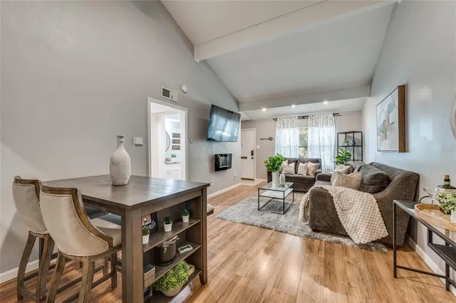 a living room with furniture a wooden floor and a sink