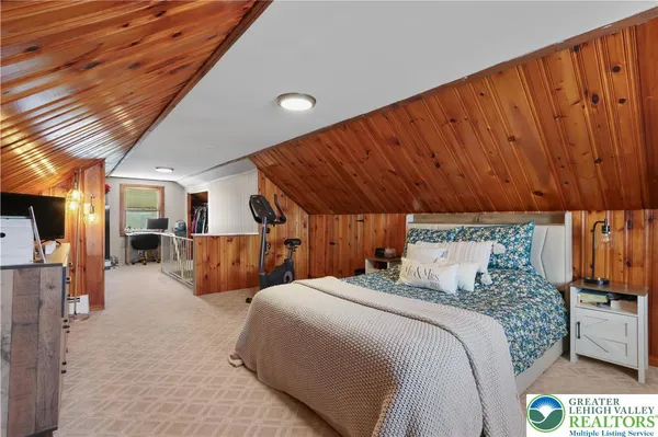a large room with bed and a large window