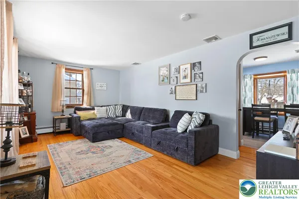 a living room with furniture window and wooden floor
