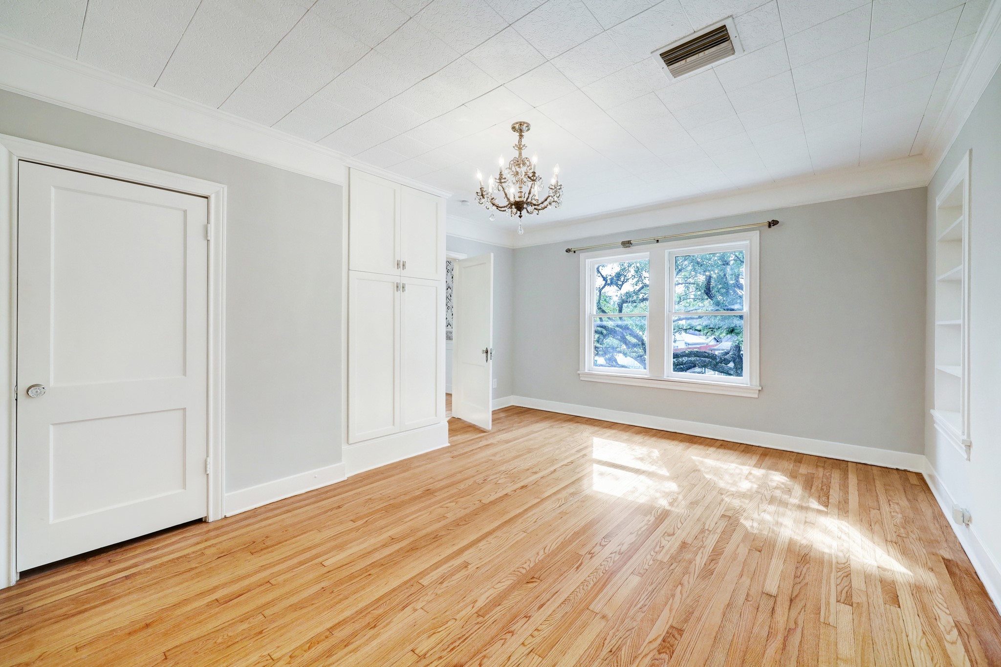1950 Lexington Street Houston, TX 77098 - Photo 13 of 16 The primary bedroom invites plenty of beautiful light with two closets and an ensuite bathroom.