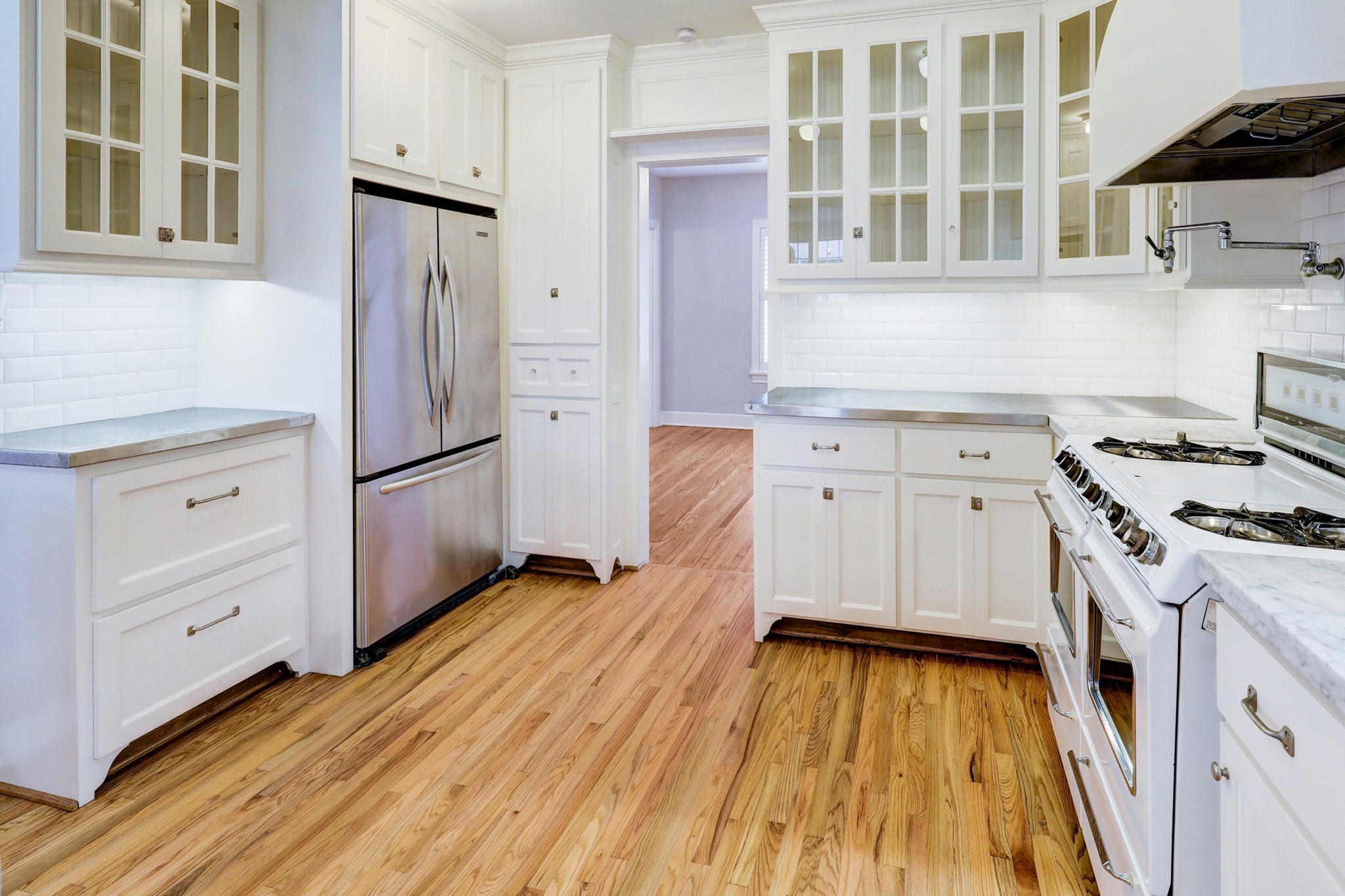 1950 Lexington Street Houston, TX 77098 - Photo 5 of 16 The kitchen boasts Carrara marble and stainless steel countertops, stainless steel appliances, and Rohl faucet/pot-filler! The kitchen has been recently remodeled with loads of light!