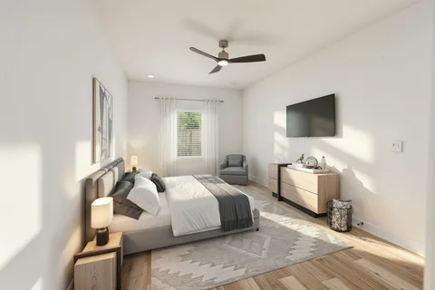 a bedroom with bed and a flat screen tv