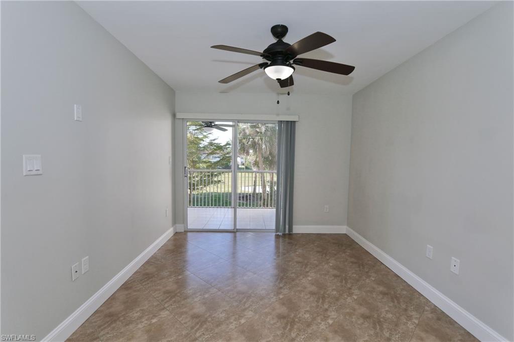 481 Quail Forest Boulevard, Unit B206 Naples, FL 34105 - Photo 6 of 16 wooden floor in an empty room with a window