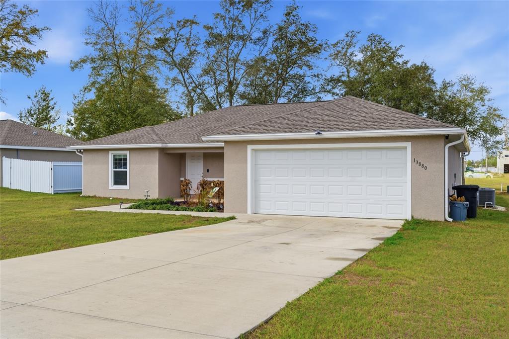 13880 Southwest 45th Terrace Ocala, FL 34473 - Photo 1 of 19 a view of a yard in front of a house with a large tree