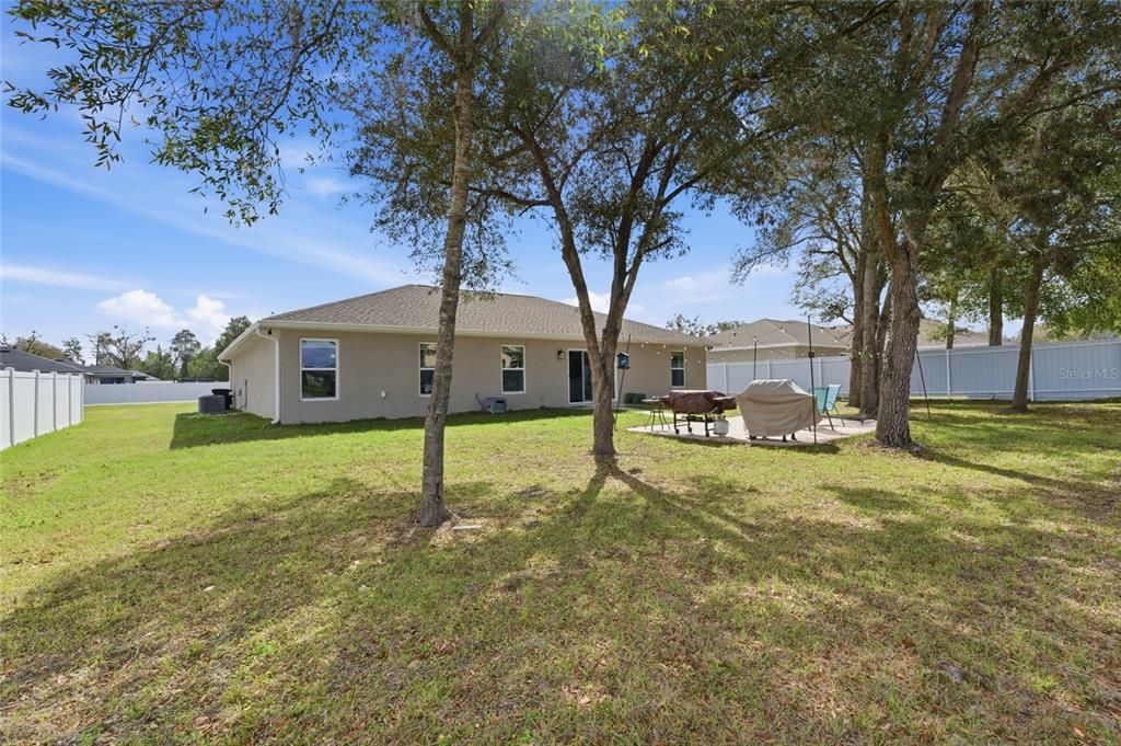 13880 Southwest 45th Terrace Ocala, FL 34473 - Photo 17 of 19 a house is sitting in middle od the garden
