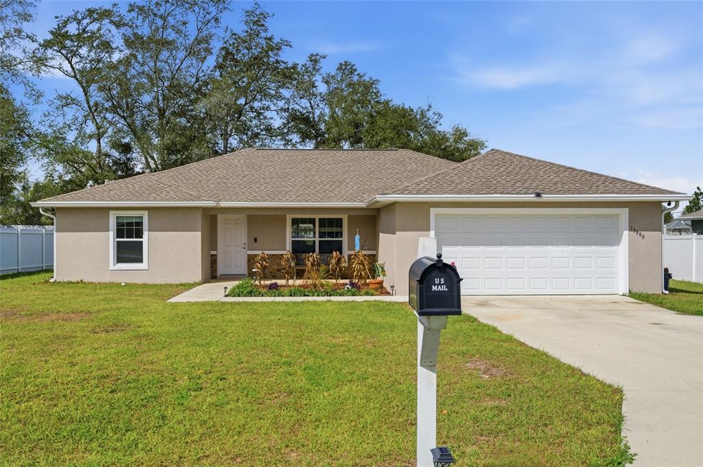 13880 Southwest 45th Terrace Ocala, FL 34473 - Photo 2 of 19 a front view of a house with patio