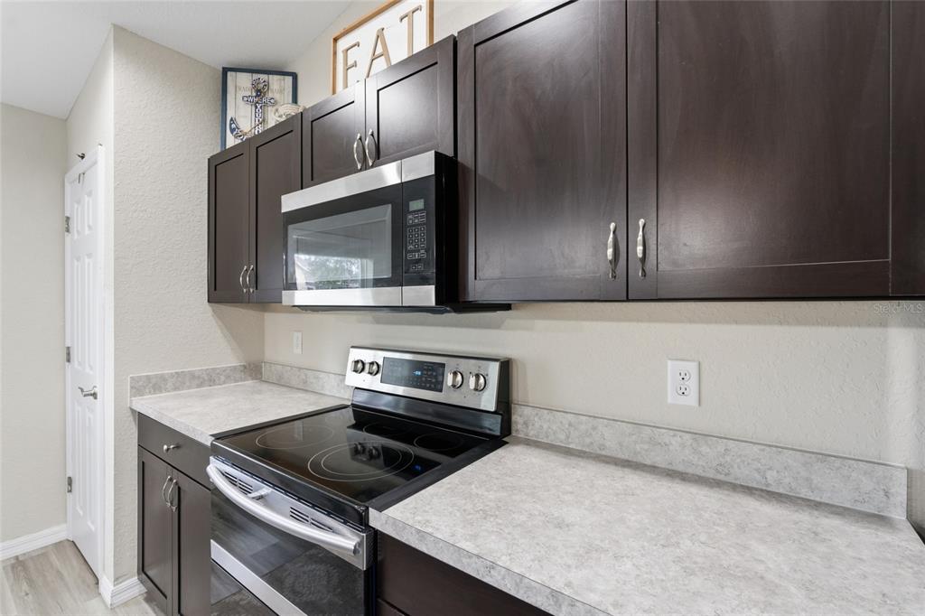 13880 Southwest 45th Terrace Ocala, FL 34473 - Photo 9 of 19 a kitchen with granite countertop a stove and a microwave