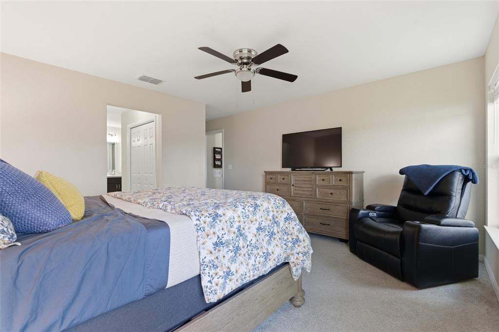 13880 Southwest 45th Terrace Ocala, FL 34473 - Photo 10 of 19 a bedroom with a bed and a flat screen tv