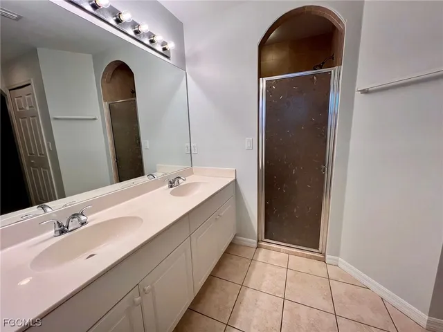 a spacious bathroom with a double vanity sink and a mirror