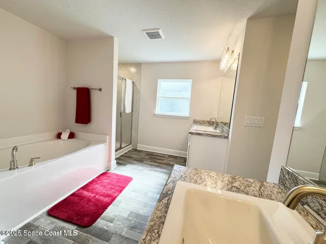 a bathroom with a shower and a bath tub