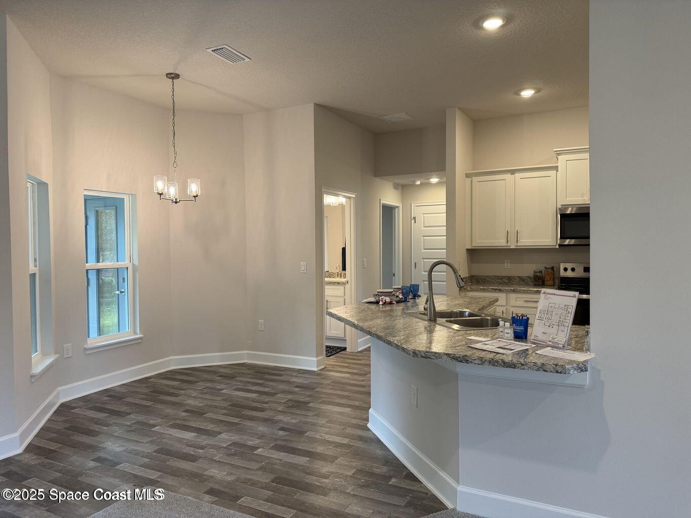 366 Faith Terrace Sebastian, FL 32958 - Photo 5 of 19 a kitchen with kitchen island granite countertop a sink cabinets and window