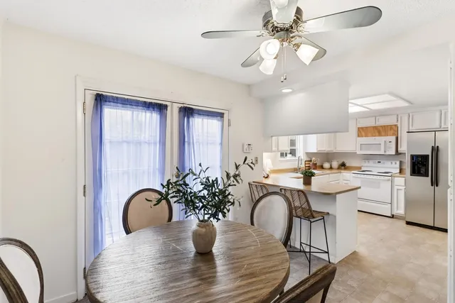 a view of a dining room with furniture and chandelier