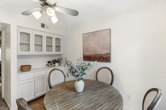 a dining room with furniture and chandelier