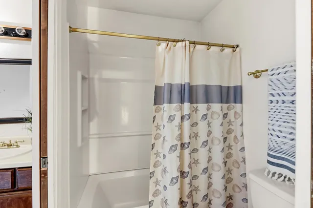 a bathroom with a shower and a sink