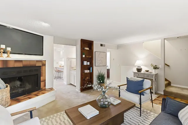 a living room with furniture and a fireplace