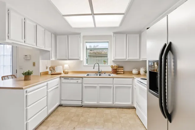 a kitchen with a sink window and cabinets