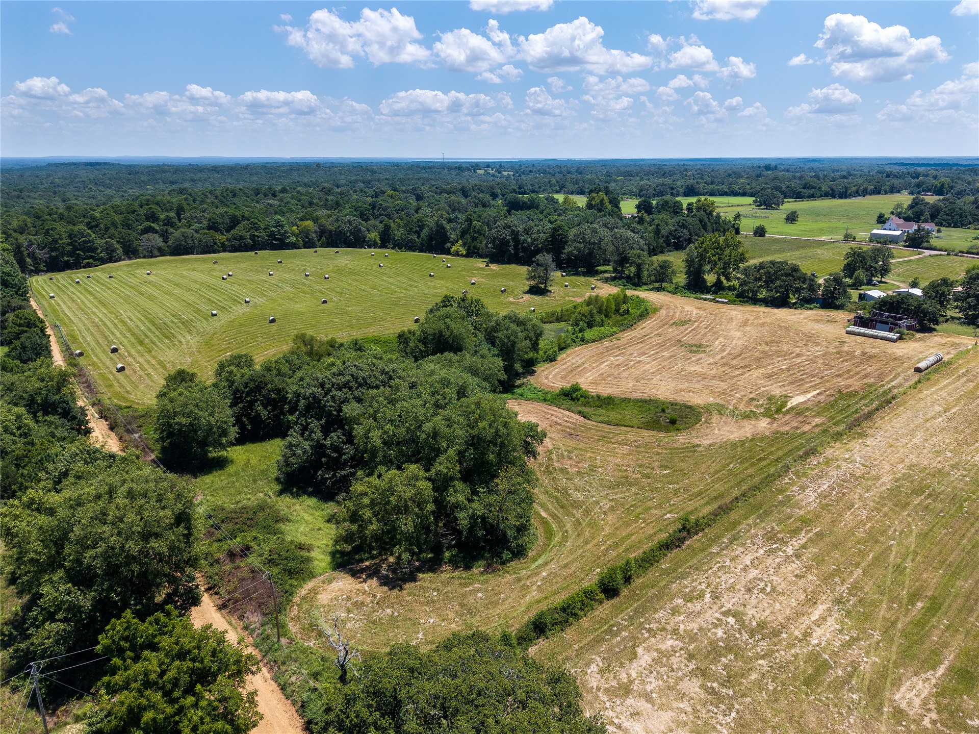 20 Red Hill Road Antlers, OK 74523 - Photo 8 of 17 Expansive property featuring varied terrain with multiple open fields, forested areas, and visible agricultural elements