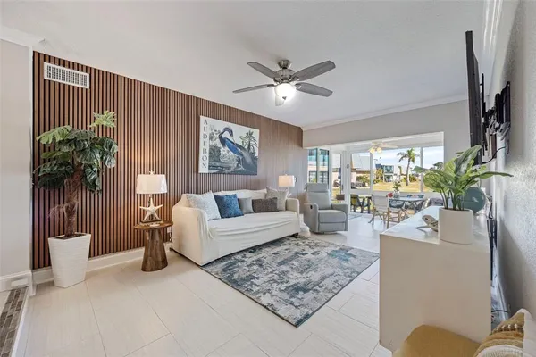 a living room with furniture and a potted plant