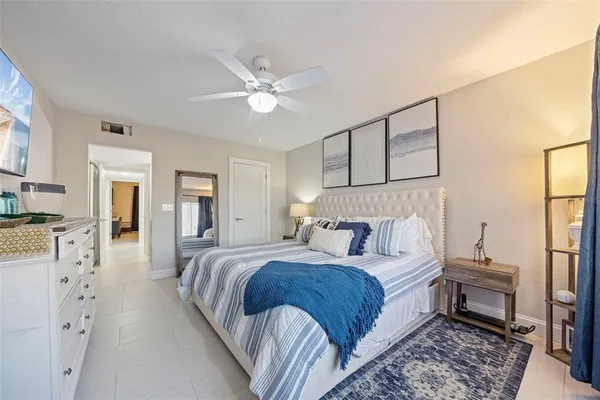 a bedroom with a large bed and a chandelier
