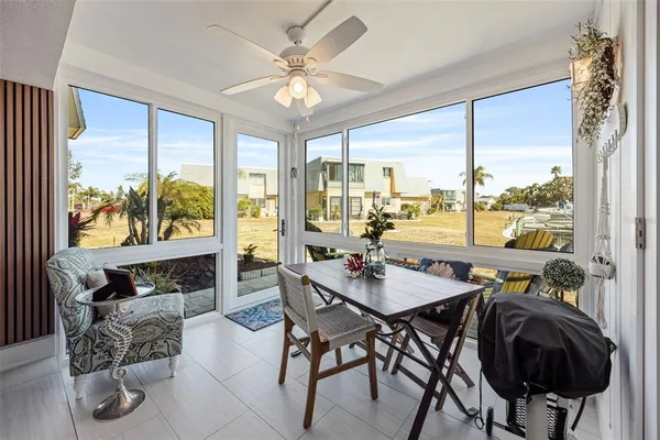 a view of a dining room with furniture large windows and wooden floor