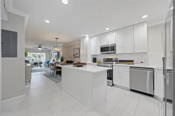 a kitchen with white cabinets and stainless steel appliances