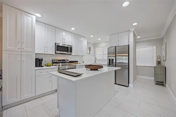 a kitchen with stainless steel appliances a refrigerator stove microwave and cabinets