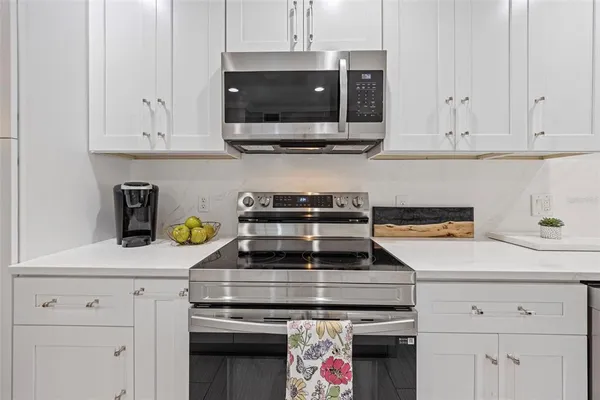 a stove top oven sitting inside of a kitchen