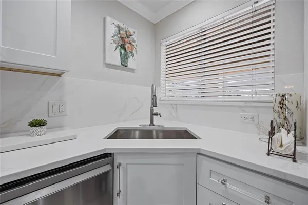 a kitchen with a sink and cabinets