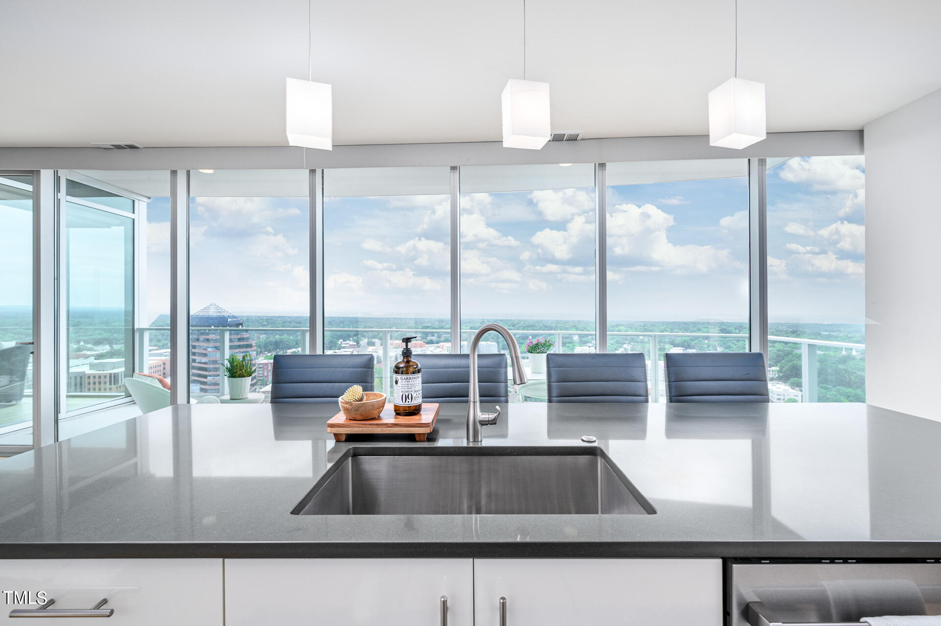 110 Corcoran Street, Unit 2301 Durham, NC 27701 - Photo 12 of 66 a view of a living room with a floor to ceiling window and kitchen view