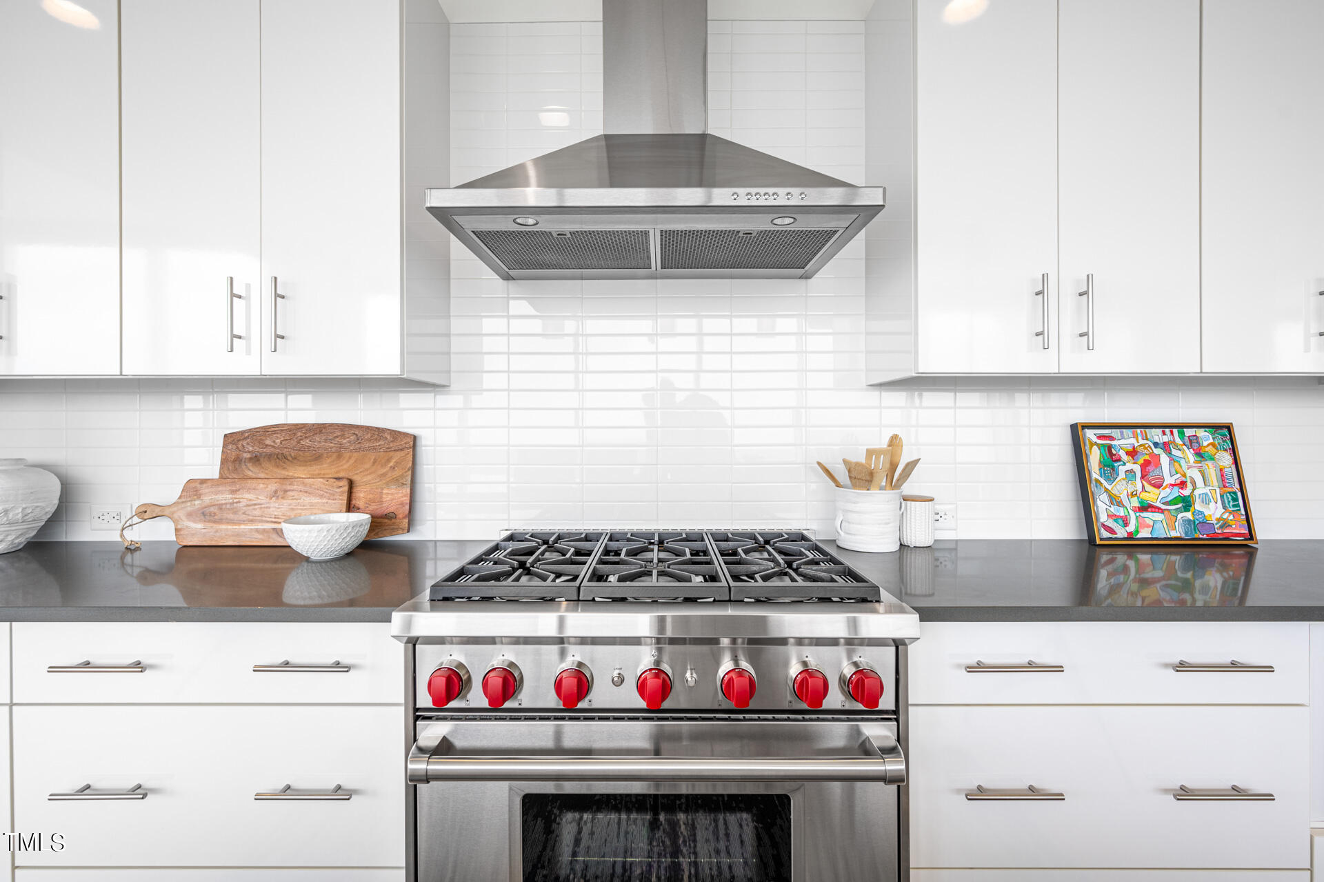 110 Corcoran Street, Unit 2301 Durham, NC 27701 - Photo 13 of 66 a kitchen with stainless steel appliances granite countertop a stove and white cabinets