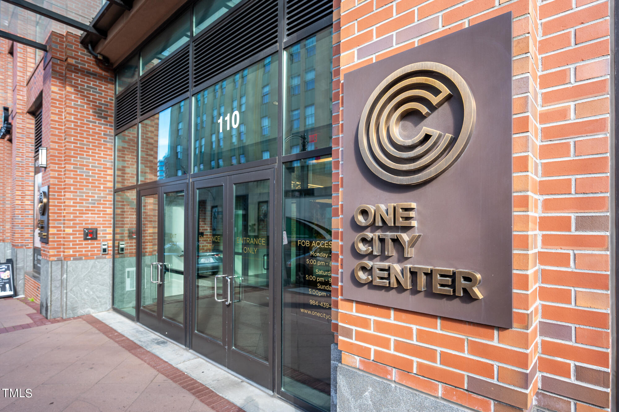 110 Corcoran Street, Unit 2301 Durham, NC 27701 - Photo 2 of 66 a front view of a building with a garden and entryway