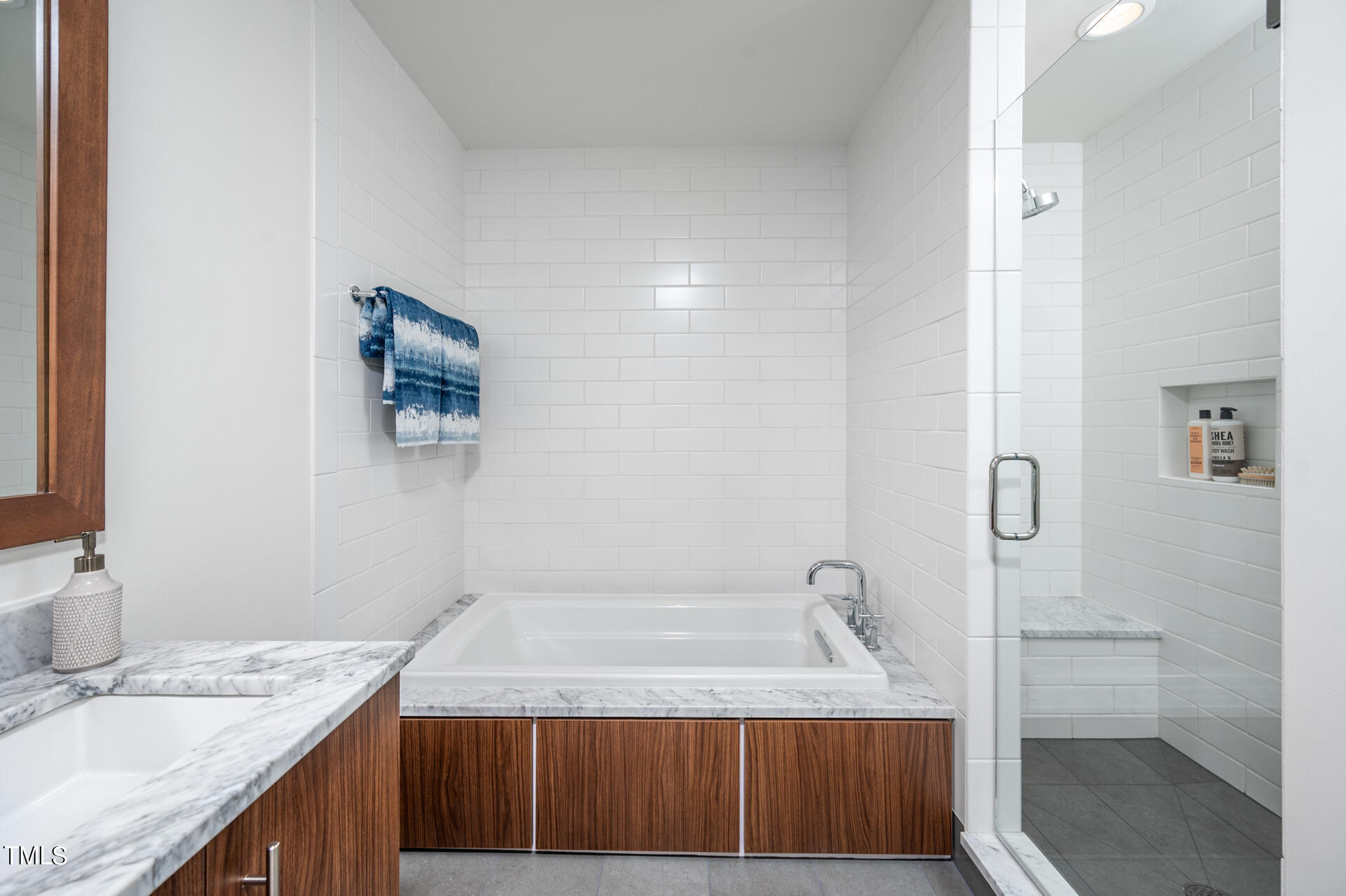 110 Corcoran Street, Unit 2301 Durham, NC 27701 - Photo 23 of 66 a bathroom with a granite countertop sink a toilet and shower