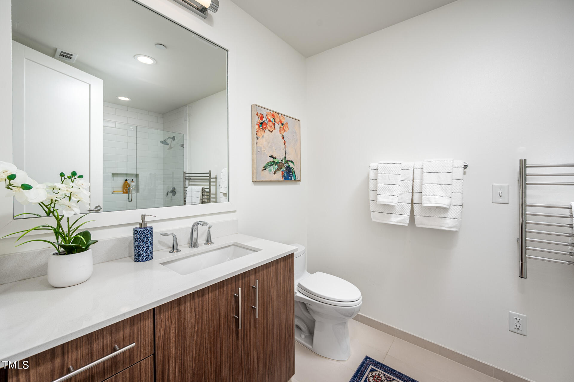110 Corcoran Street, Unit 2301 Durham, NC 27701 - Photo 28 of 66 a bathroom with a sink a toilet and a large mirror