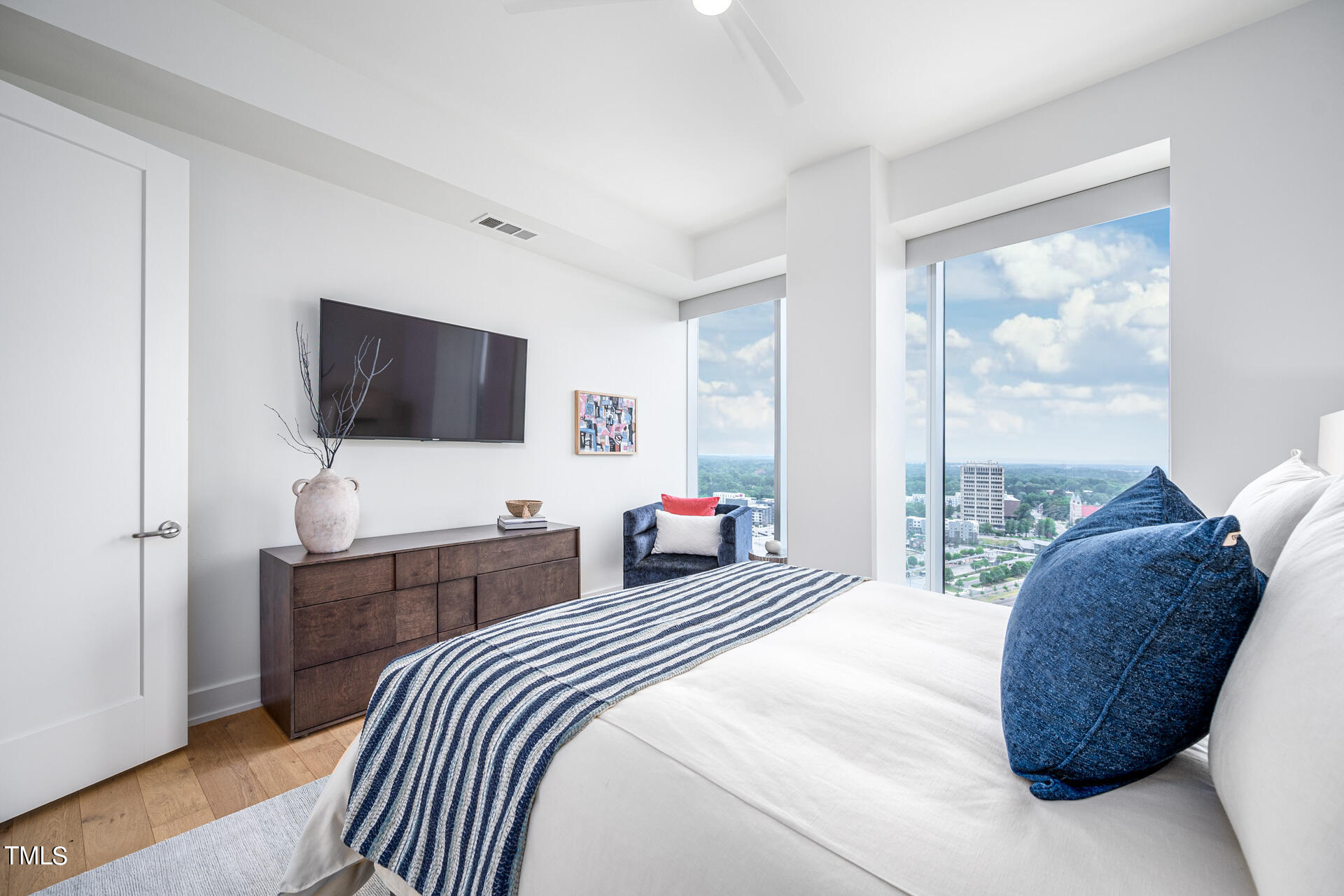 110 Corcoran Street, Unit 2301 Durham, NC 27701 - Photo 31 of 66 a bedroom with a bed and a flat screen tv