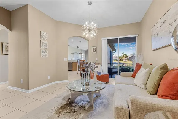 a living room with furniture a dining table and a chandelier