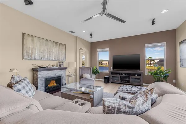 a living room with furniture a fireplace and a flat screen tv