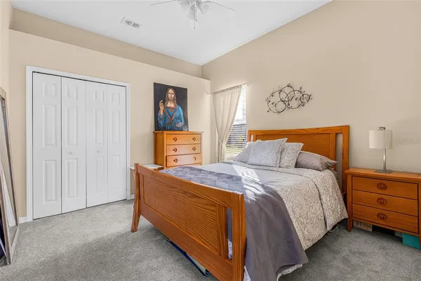 a bedroom with a bed and a night stand