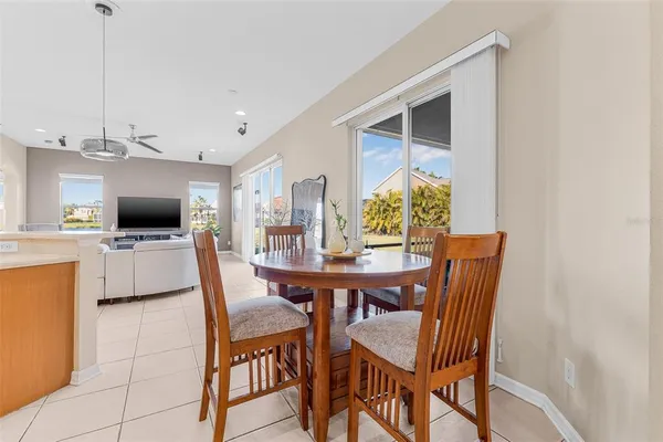 a view of a dining room with furniture and a kitchen