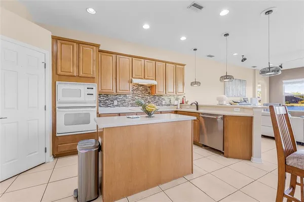 a kitchen with a refrigerator sink and cabinets