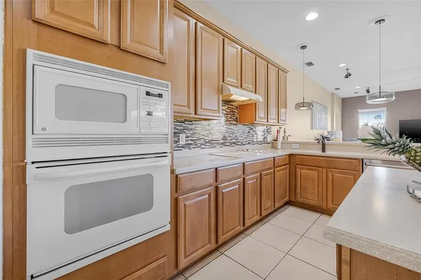 a kitchen with granite countertop white cabinets stainless steel appliances and a sink